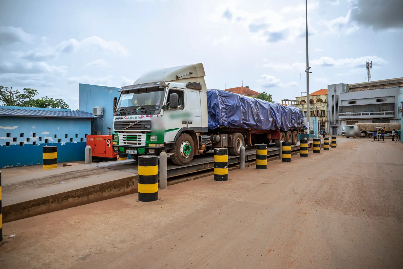 A loaded articulated truck standing on the weighbridge, its trailer sheeted end to end.